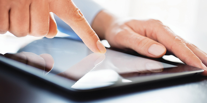 Finger pointing on a touch screen tablet.