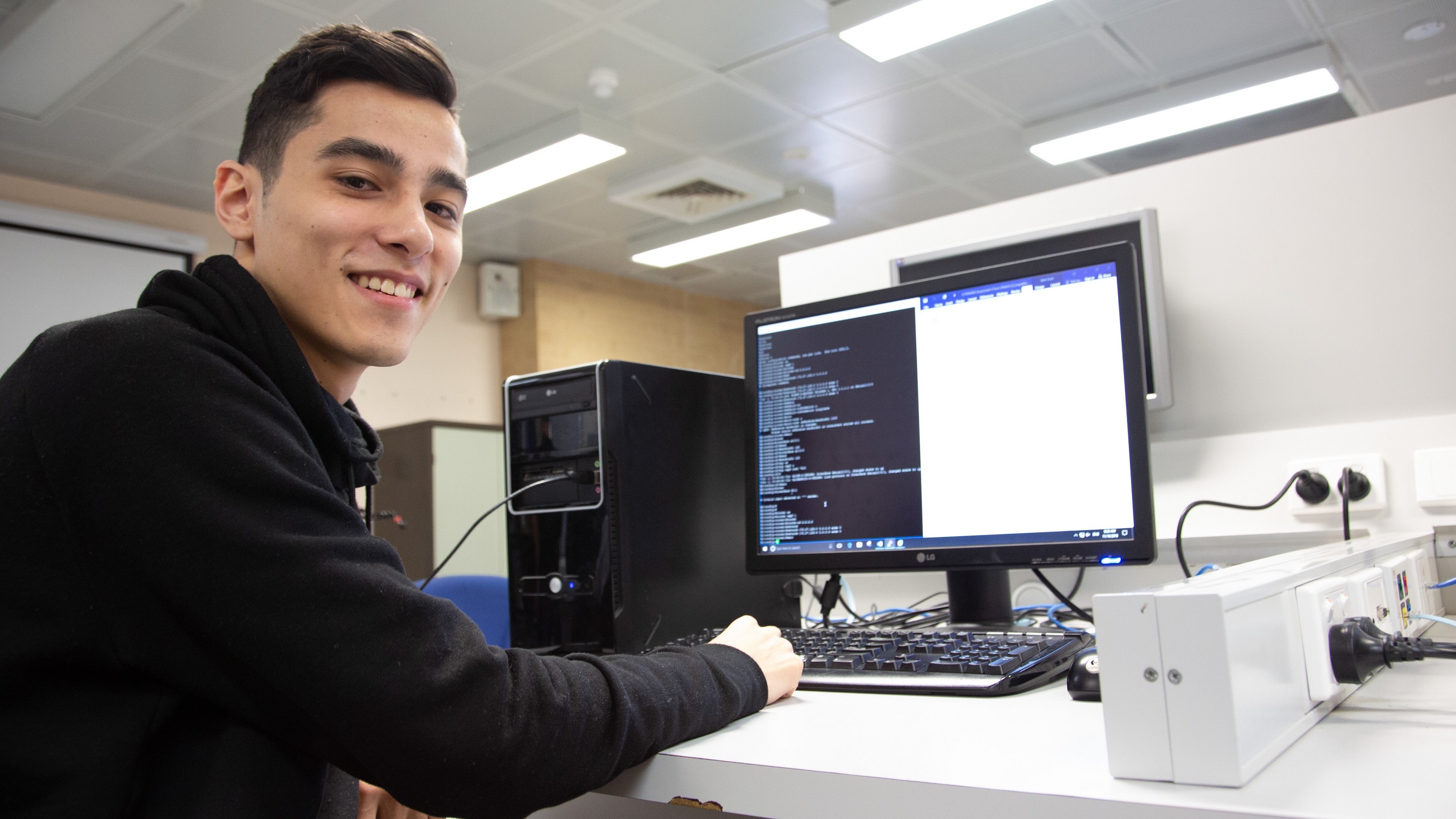 Photo of student sitting in front of computer 