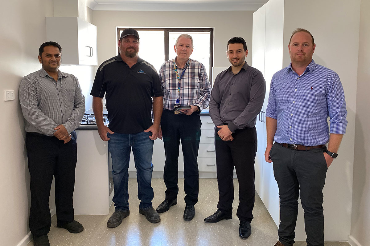 A group shot of members of Westport Construction, who were involved in the refurbishment of a public housing property in Greenwood.