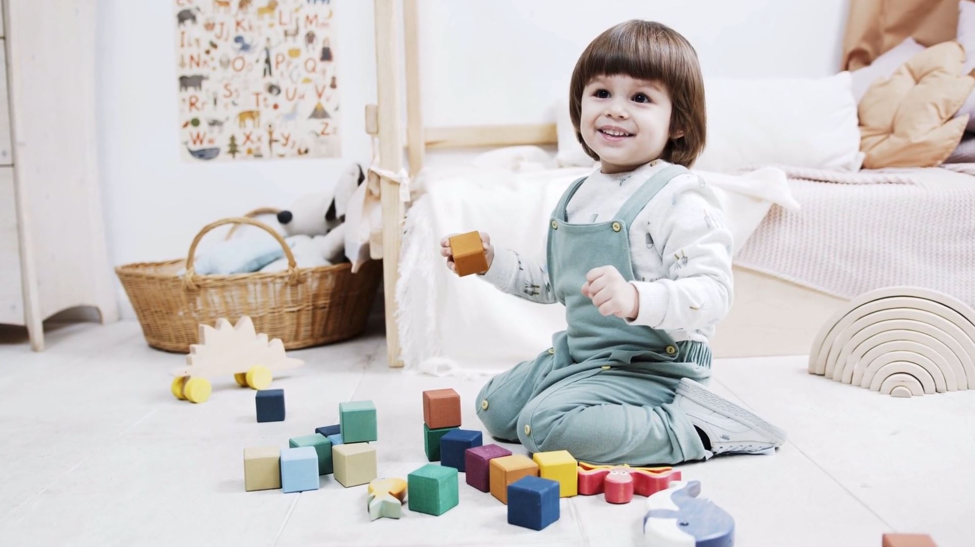 A young toddler is playing with building bricks