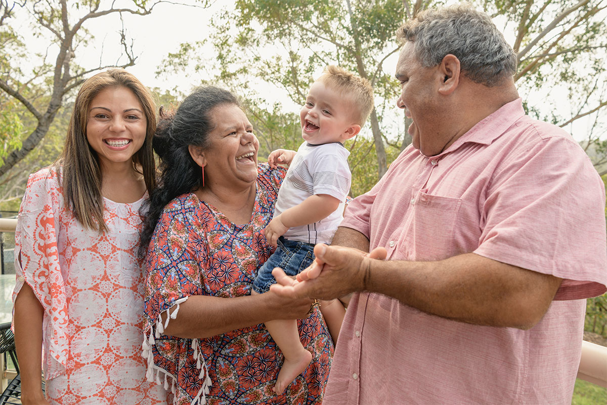 Four members of a happy family spanning three generations.