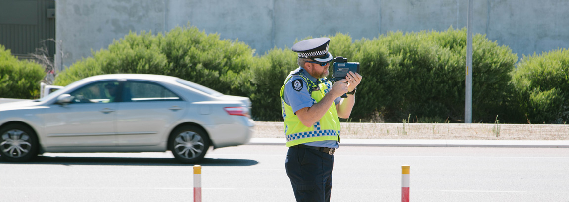 Policeman with speed detection gun