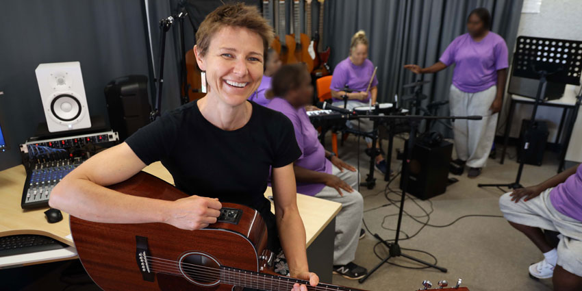 Ange Leech holding the guitar