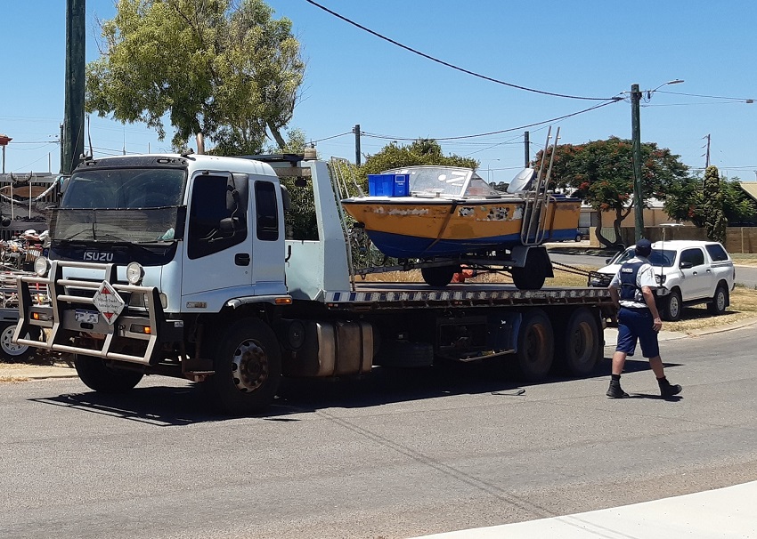 small boat on the back of a truck