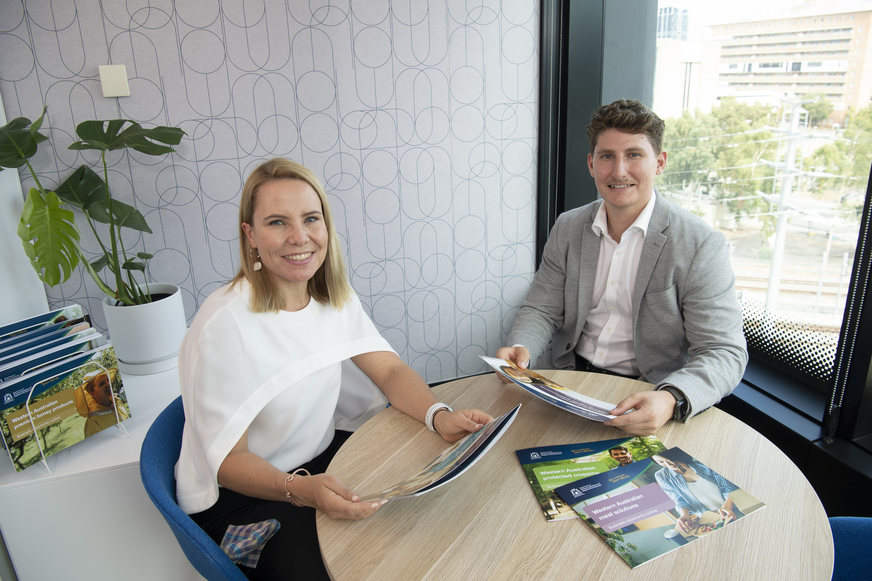 two DPIRD staff members reading the business opportunity outline in an office