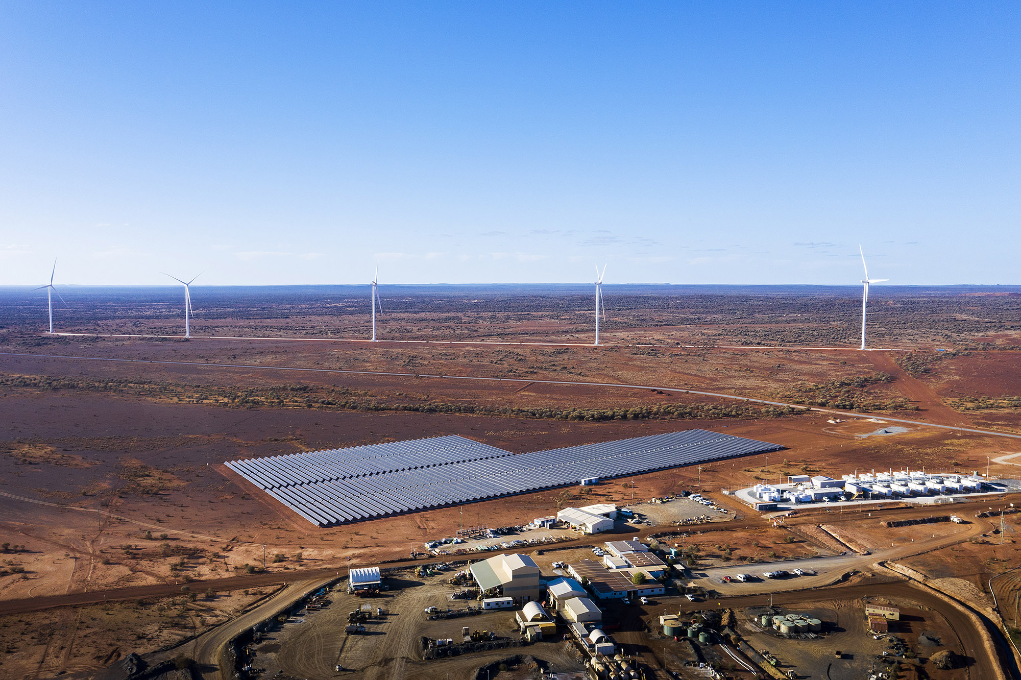 Agnew Mining Site with Renewable energy setup - drone shot of mine site with wind turbines and solar panels.