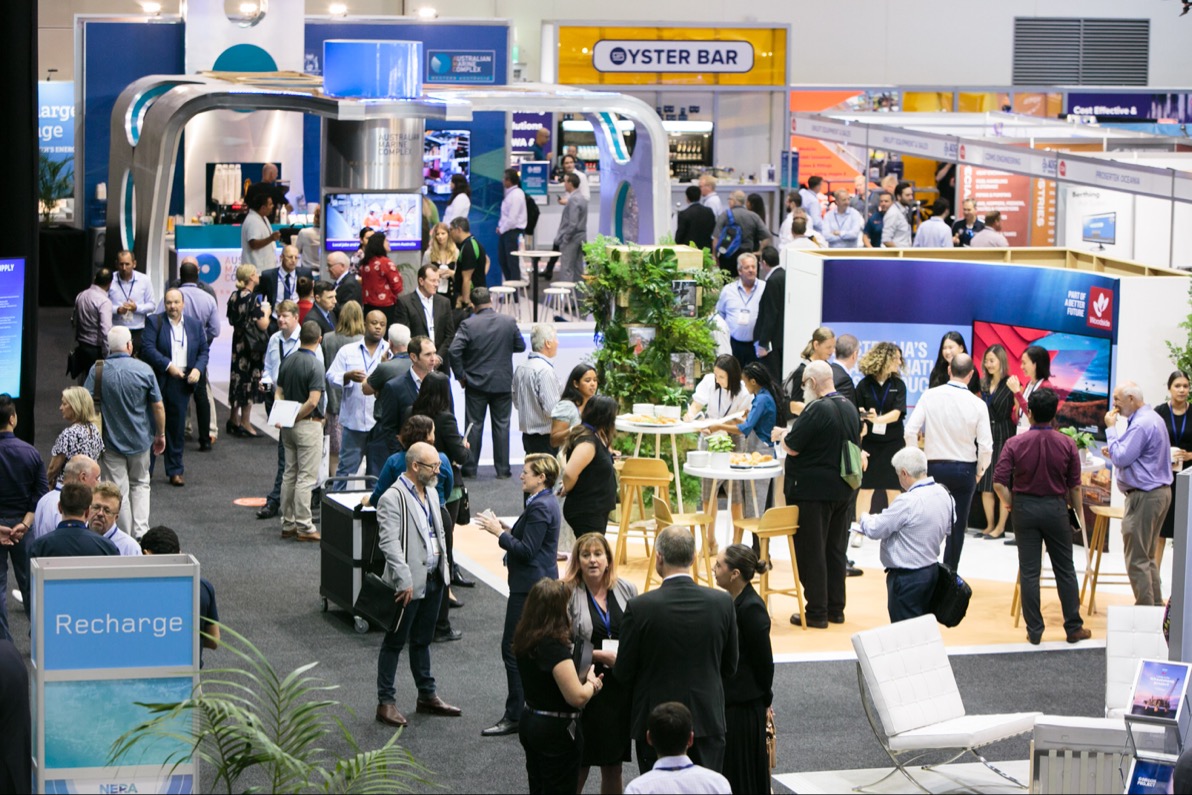 Attendees network on the exhibition floor at an AOG Energy conference