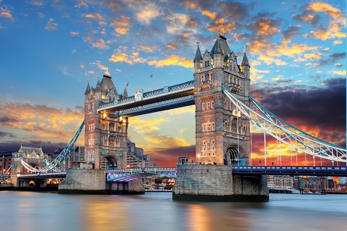 Tower Bridge in London at sunset with lit up buildings in the background