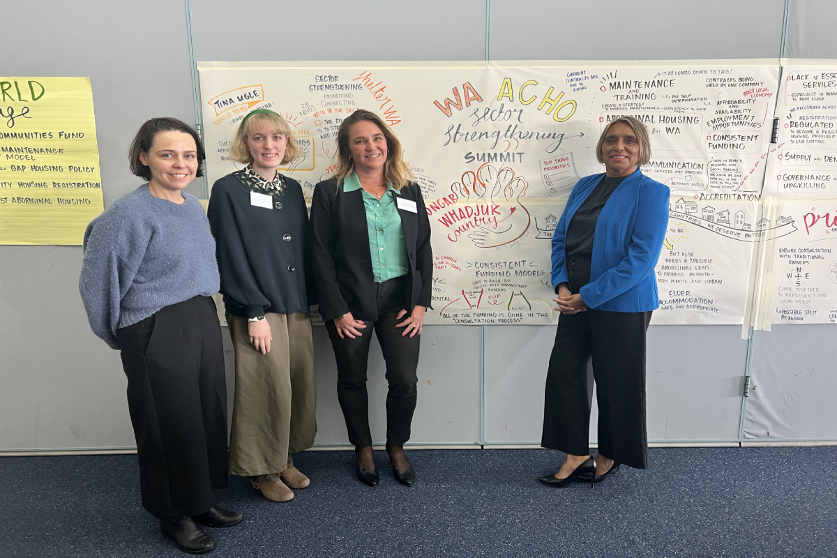 Staff in front of whiteboard