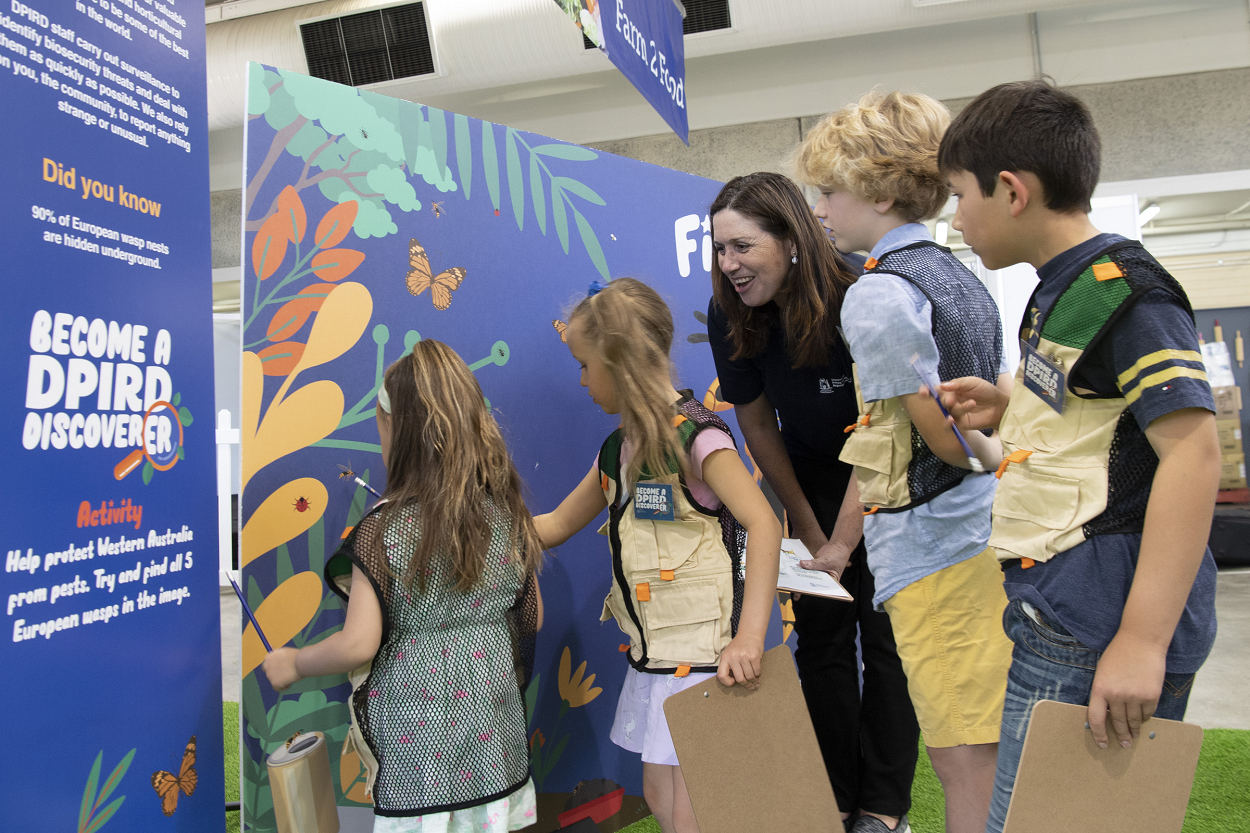 DPIRD staff and young show-goers looking at interactive board