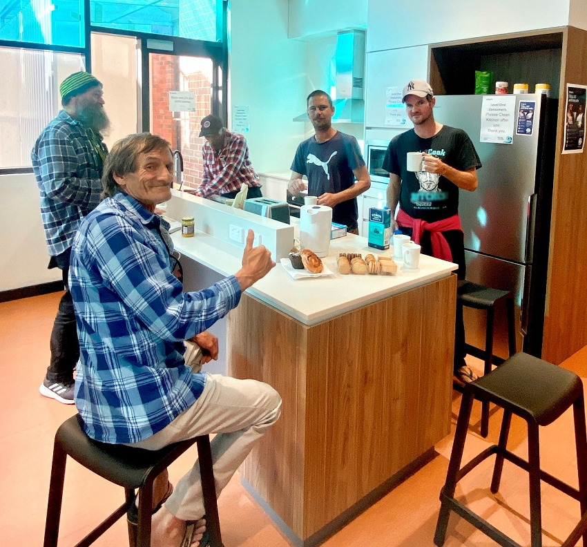 Photo of a group of men in St Bart's kitchen area