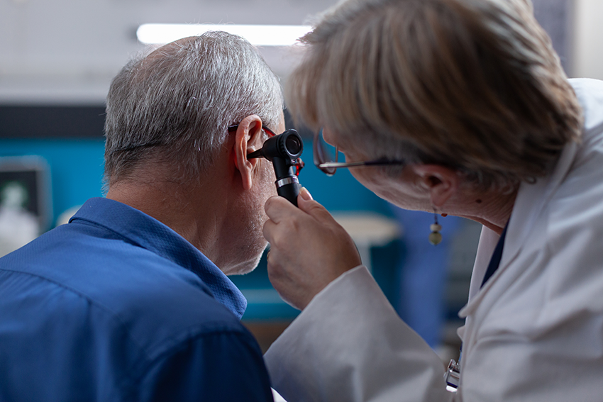 Doctor holding otoscope