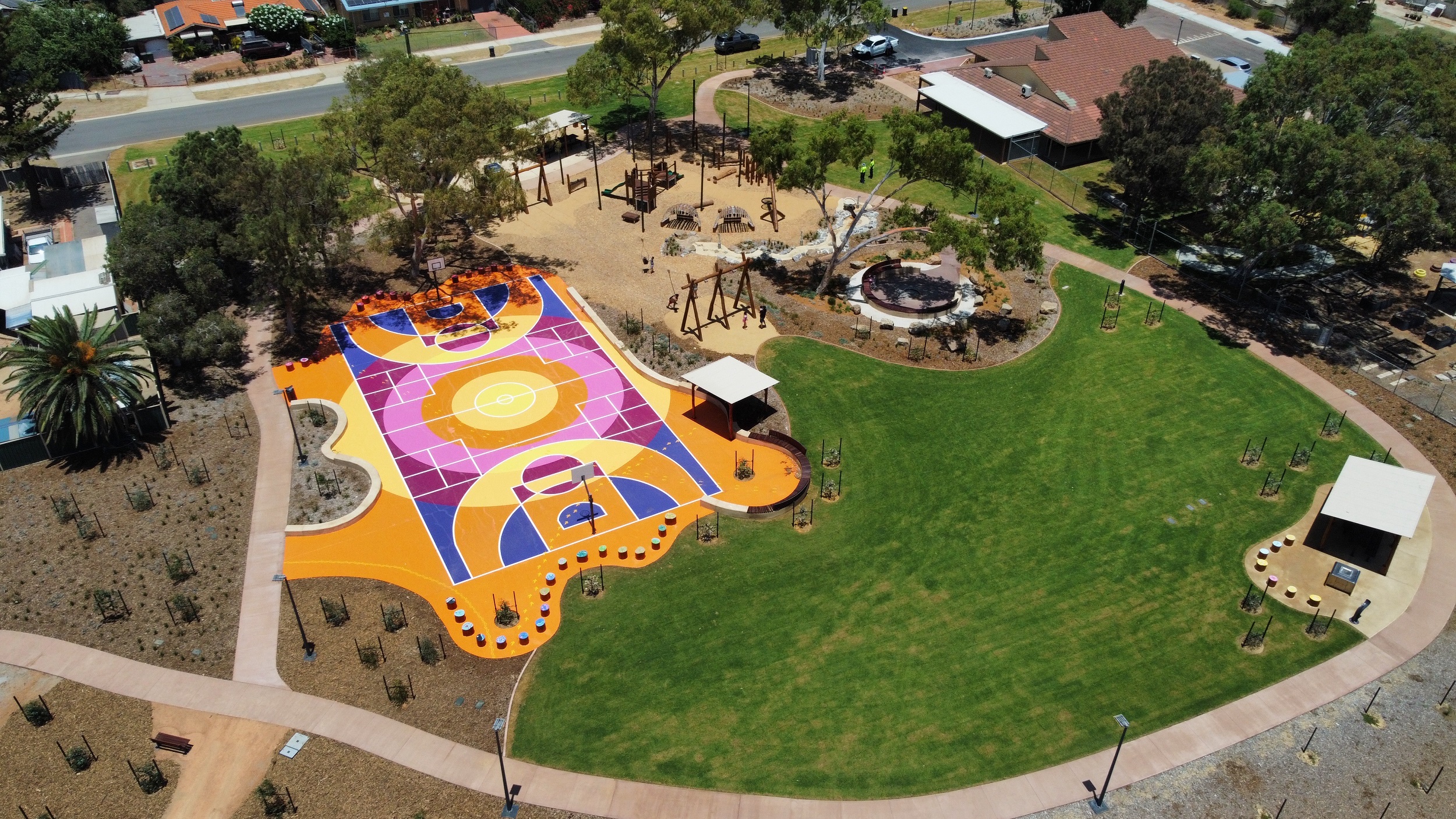 aerial photo of community parklands with playgrounds and basketball courts