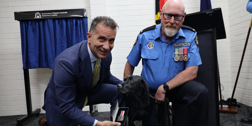 Corrective Services Minister Paul Papalia with Drug Detection Officer Glen and detection dog Aria