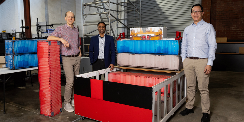 three men standing with colourful grids