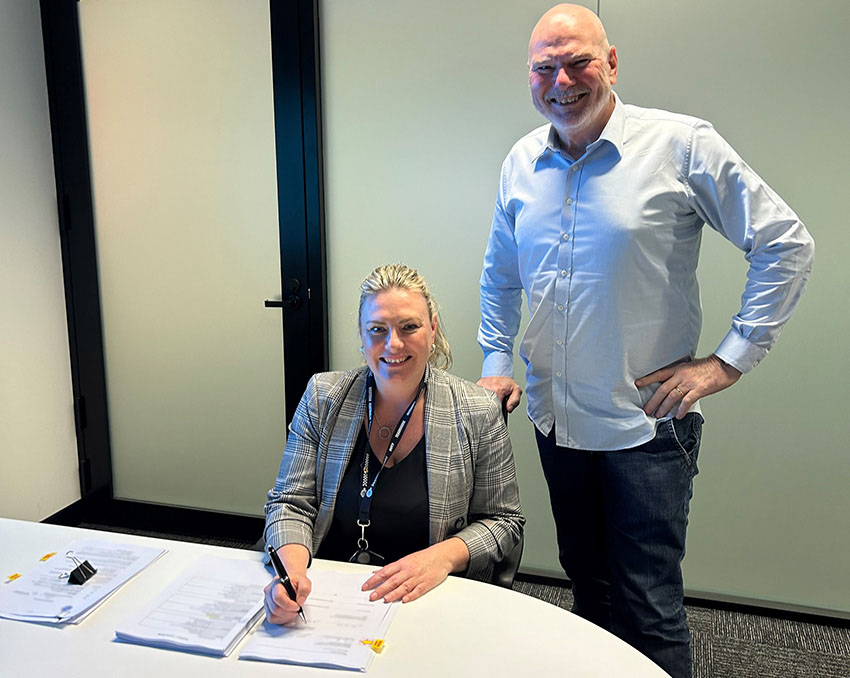 Amanda Smith, Project Manager – Camera Procurement is joined by Road Safety Commissioner Adrian Warner to sign the safety camera trailer contract