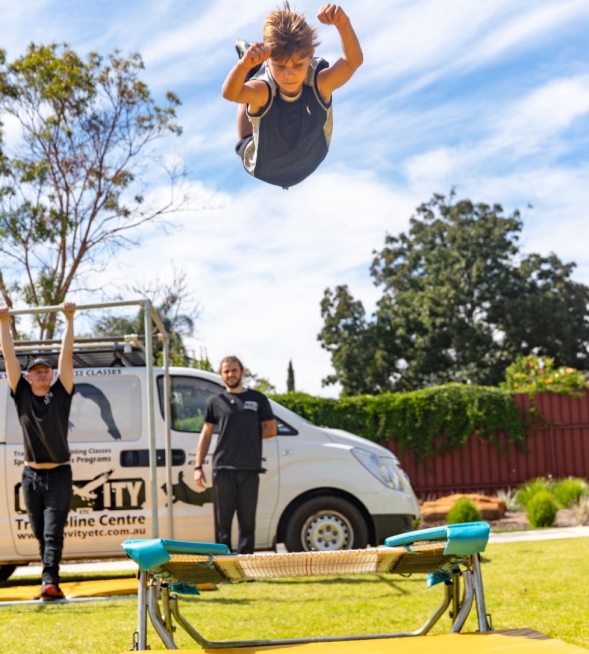 Photo of a boy playing in a playground, mid air