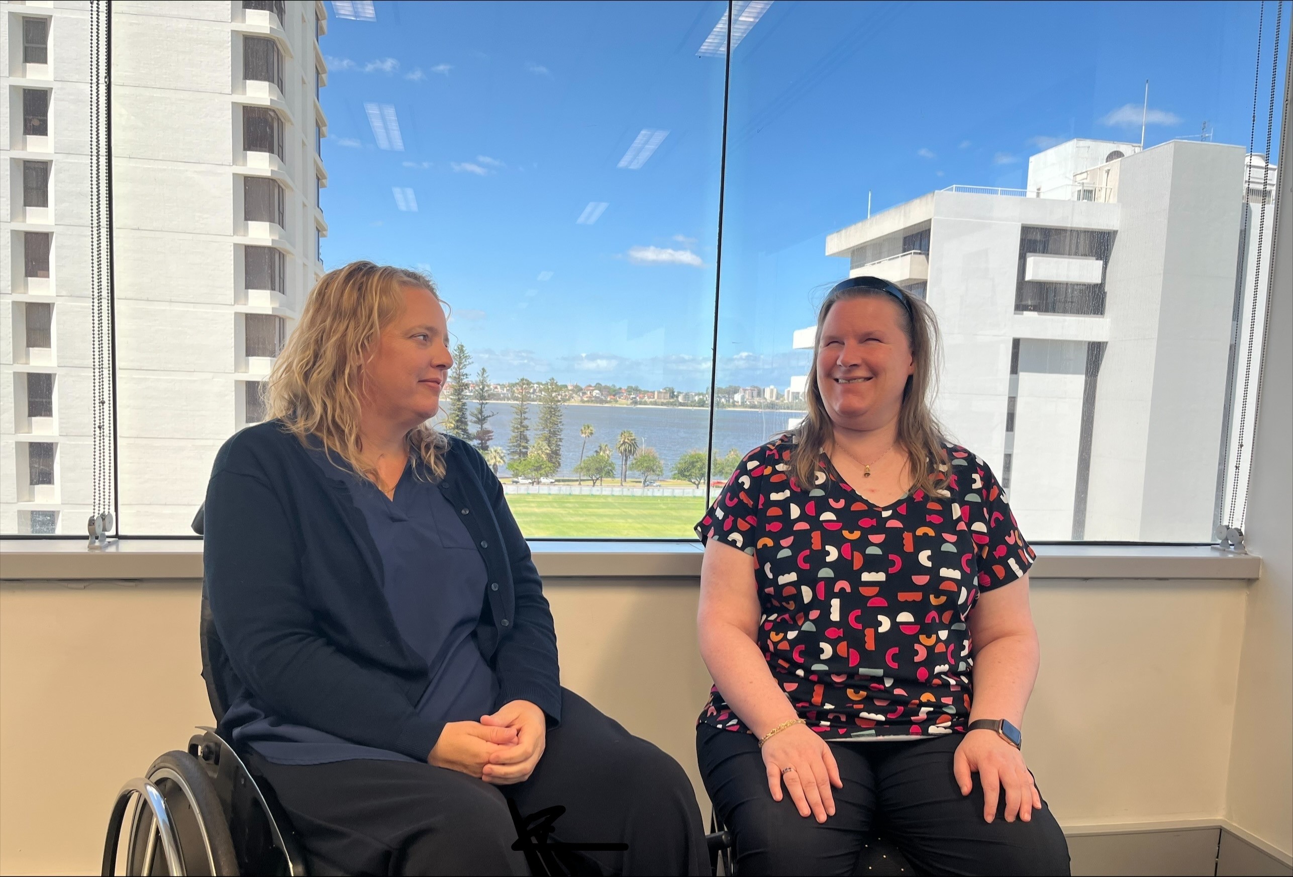 Image of two Communities staff members in an office setting