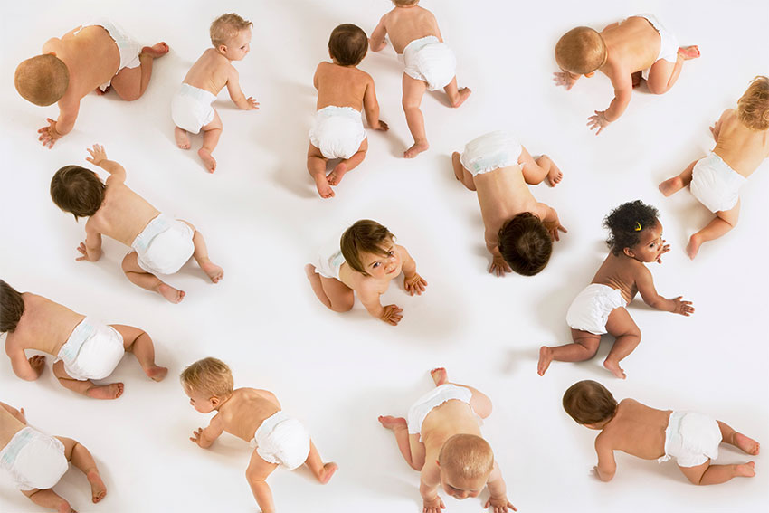 A photo of babies crawling on floor