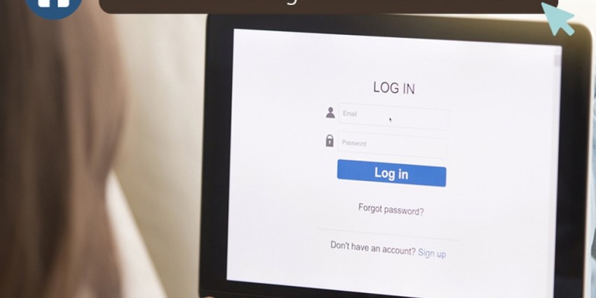 A person using a laptop to access a log in screen.