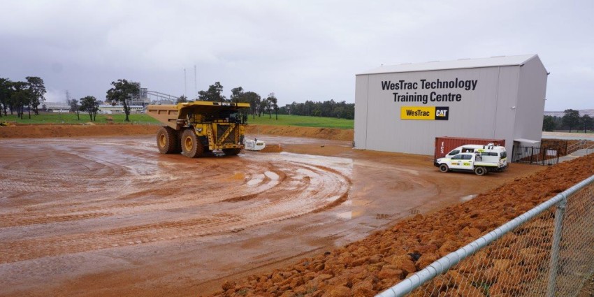 A Caterpillar haul truck sits on the wet dirt track at the Collie Westrac Technology Training Centre