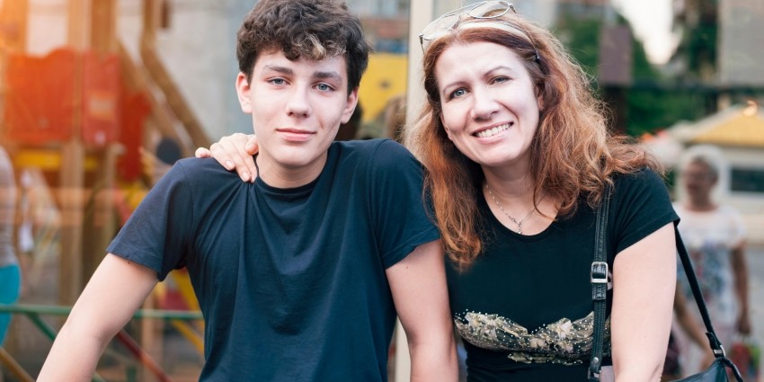 A mother with the arm around her teenage son