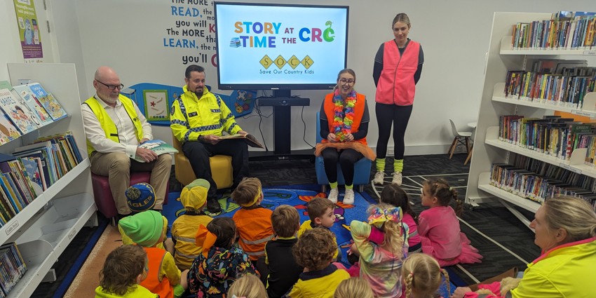 The Commissioner reads a story to children in the library in Narembeen