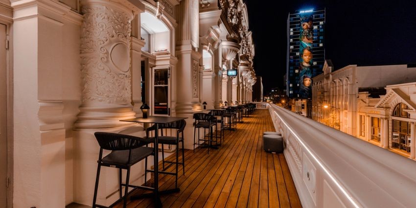 Balcony of His Majesty's Theatre with bar stools and tables