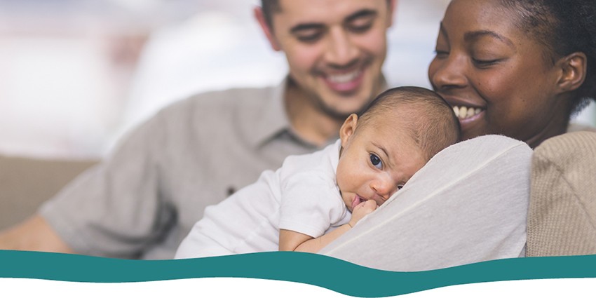 Parents holding newborn baby in their arms