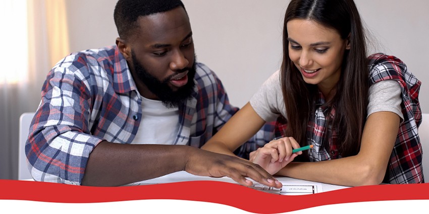 A man and woman looking at paperwork